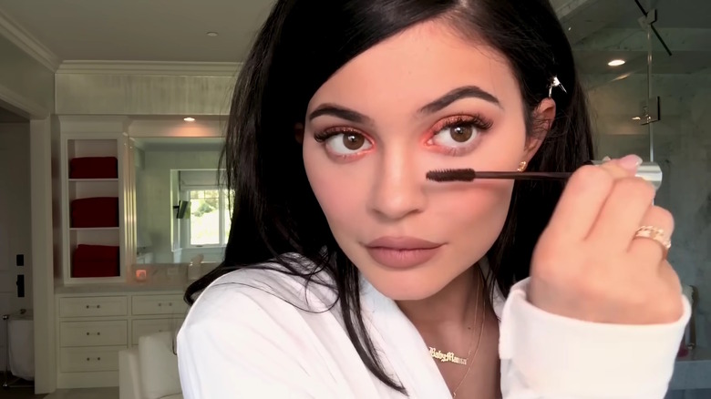 Kylie Jenner putting on mascara