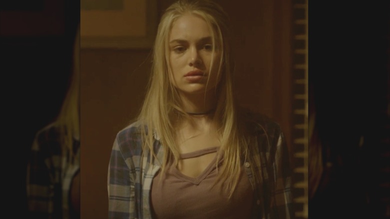 Randolph wearing plaid jacket with hair down in a still from "House of the Witch" (2017)