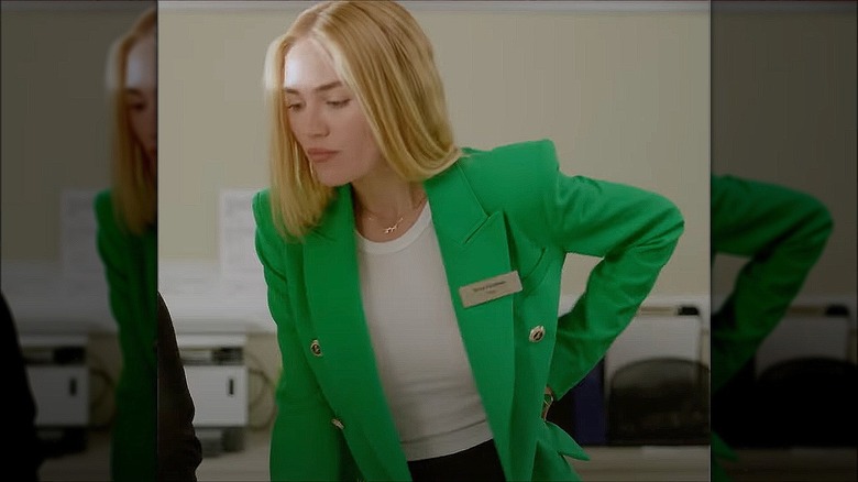 Michelle Randolph in green blazer with hand on hip in "The Throwback" (2024)