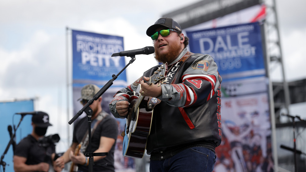 Luke Combs playing his guitar