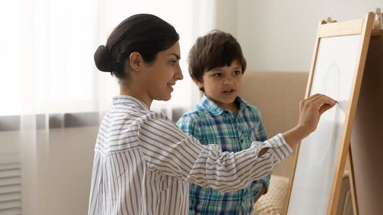 A woman and little boy drawing 