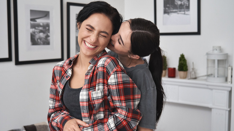 Couple embraces and smiles