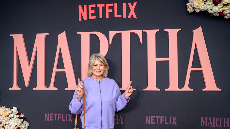 Martha Stewart smiling in front of backdrop for her documentary