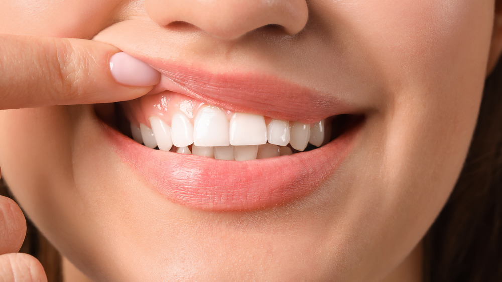 Woman smiling and pulling her lip up.