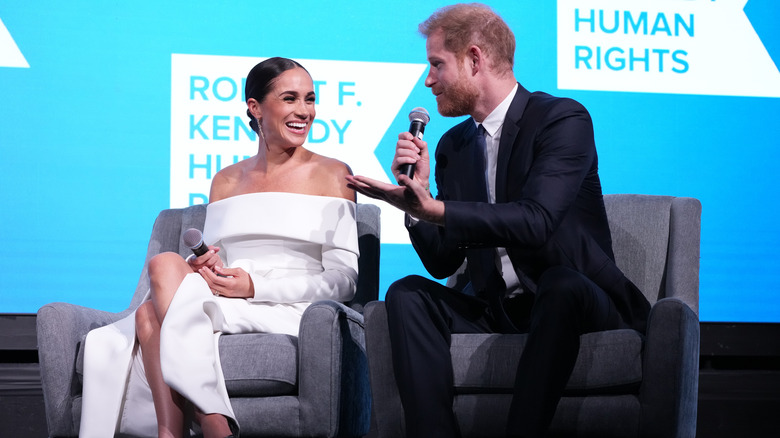 Meghan and Harry smiling during interview