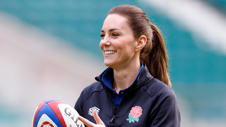 Kate Middleton smiling with rugby ball