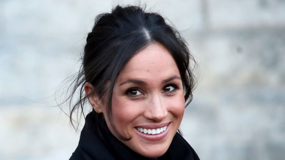 Meghan Markle smiles for photographers 