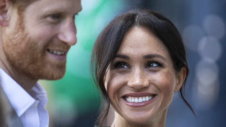 Meghan Markle smiling at Prince Harry