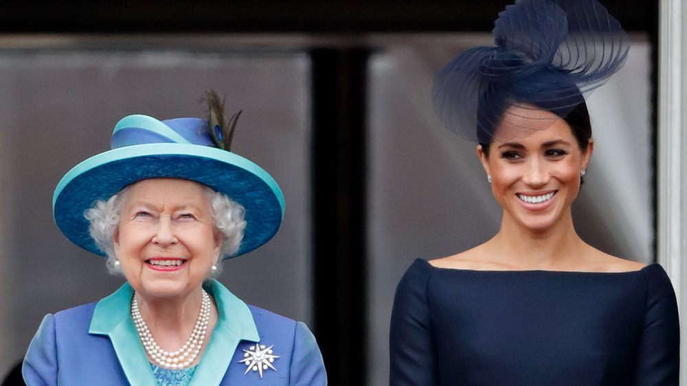 Meghan Markle smiling with the Queen