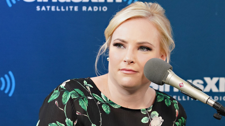 Meghan McCain in front of a microphone