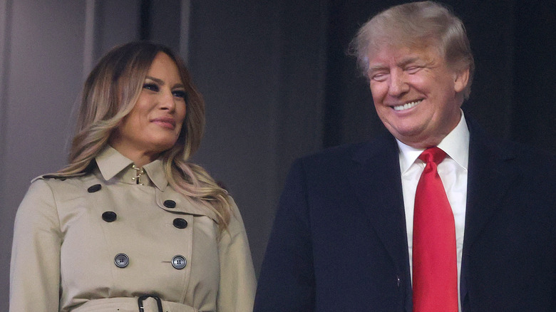 Melania Trump smiles at smiling Donald Trump