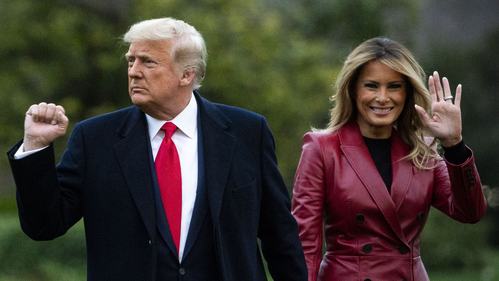 Donald Trump gives a fist as Melania Trump waves