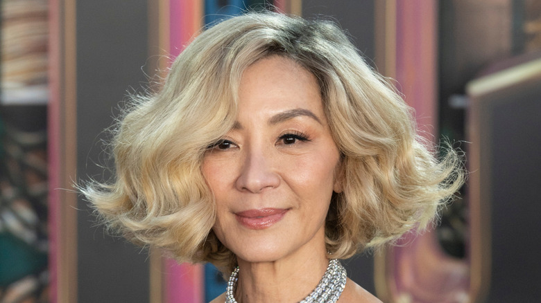 Michelle Yeoh smiling with blonde hair