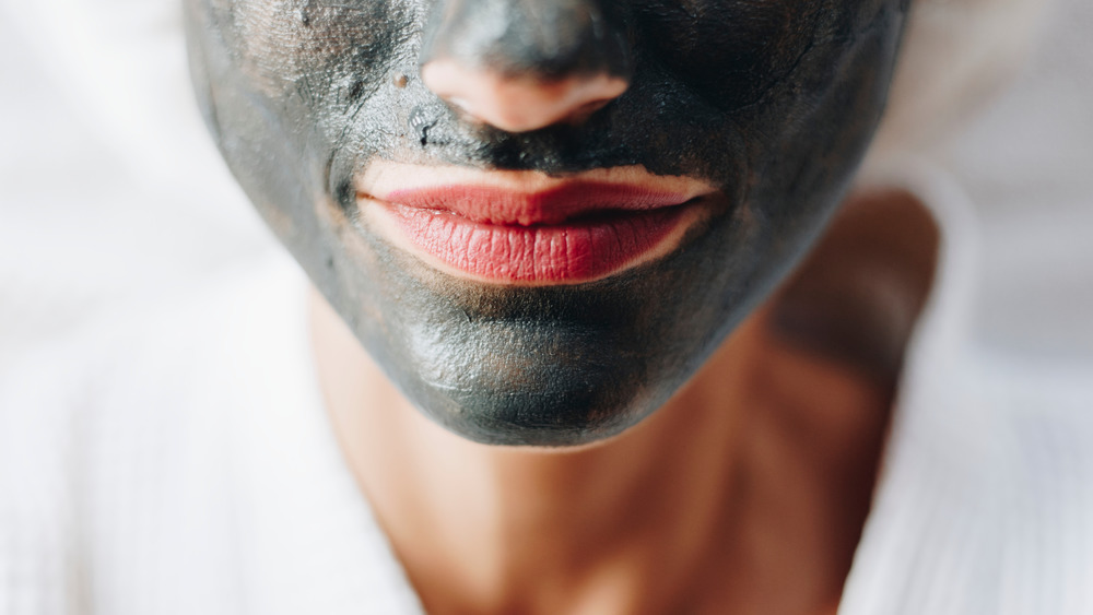 Person wearing a mud mask