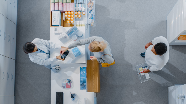 Patients picking up medications from pharmacy 