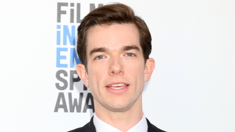 John Mulaney poses on the red carpet