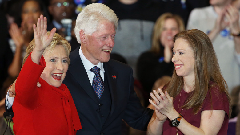 Hillary, Bill, and Chelsea Clinton smiling