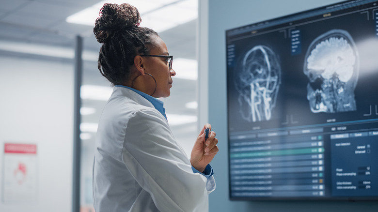 Scientist looking at a brain scan on computer screen