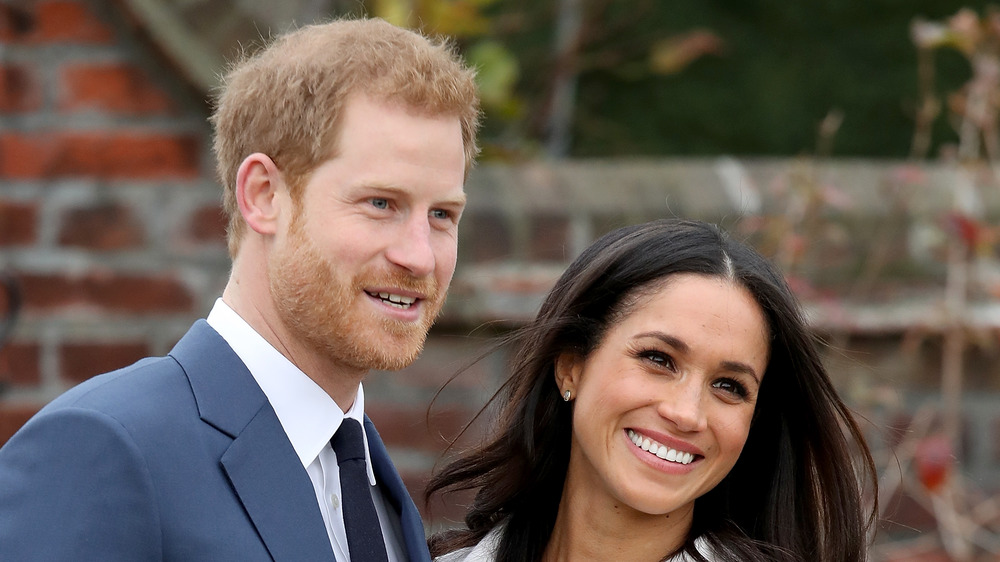 Meghan and Harry smile for photographers