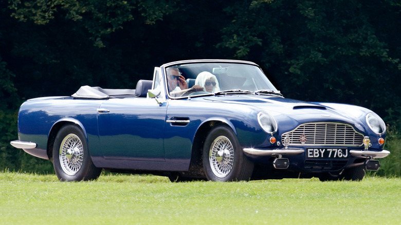 Prince Charles driving Aston Martin