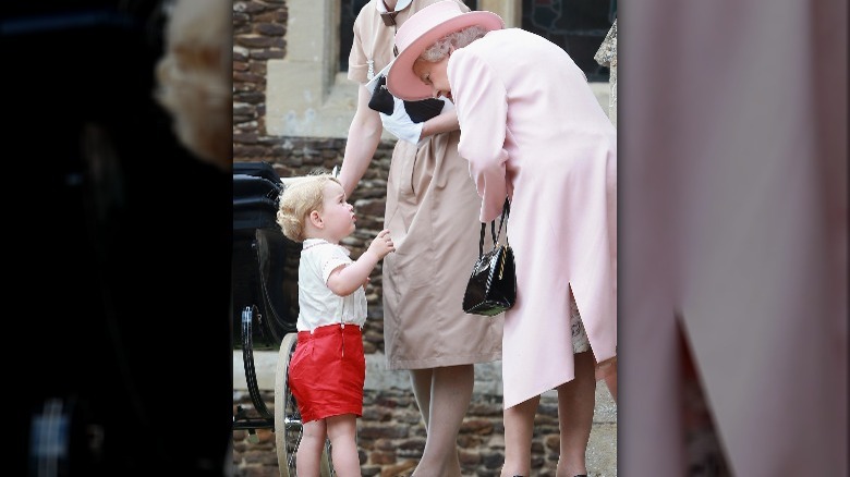 A young Prince George talking to Queen Elizabeth