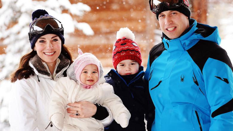 Kate Middleton posing with Princess Charlotte, Prince George and Prince William against a snowy background