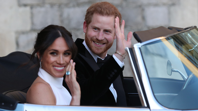 Prince Harry and Meghan Markle waving at their wedding