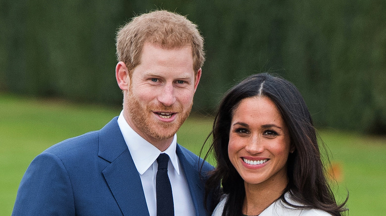 Prince Harry and Meghan Markle smile for the camera.