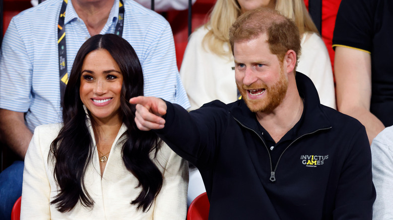 Prince Harry points something out to Meghan Markle