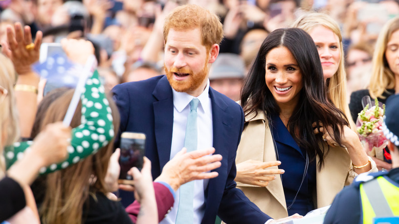 Prince Harry and Meghan Markle react to growing crowds