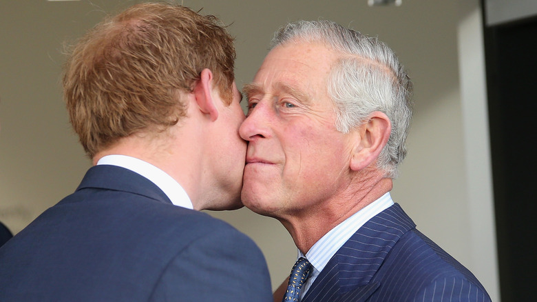 Prince Harry giving King Charles a kiss on the cheek