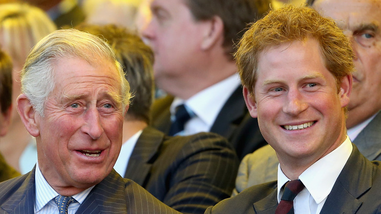 King Charles and Prince Harry smiling