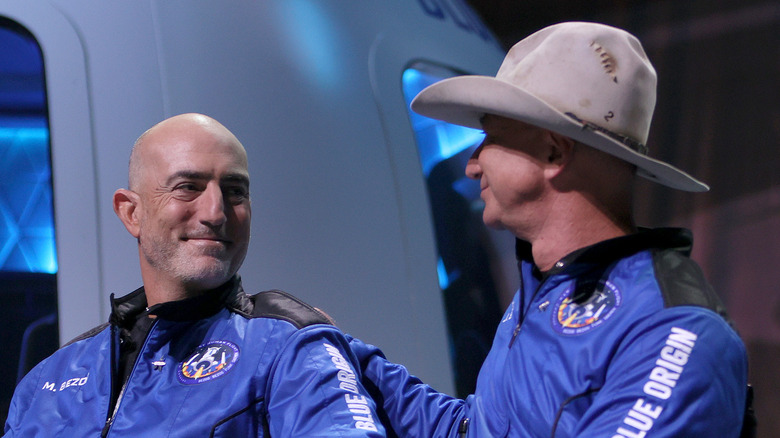 Mark and Jeff Bezos in blue space suits 