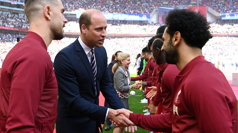 Prince William meets soccer players at a match