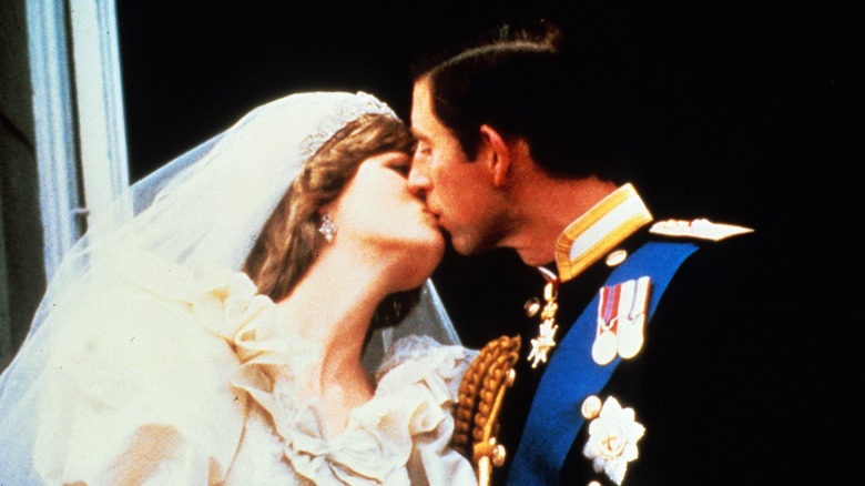 Princess Diana kissing Prince Charles on their wedding day