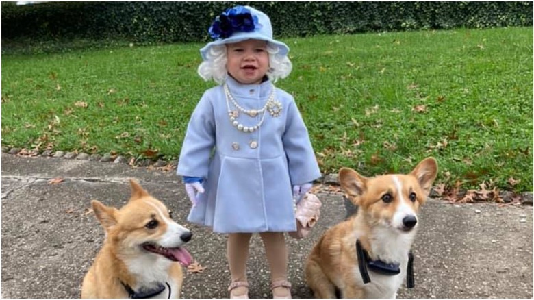 Little girl dressed as Queen Elizabeth II. 