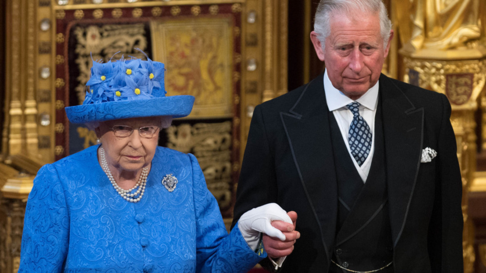 Queen Elizabeth is escorted by Prince Charles