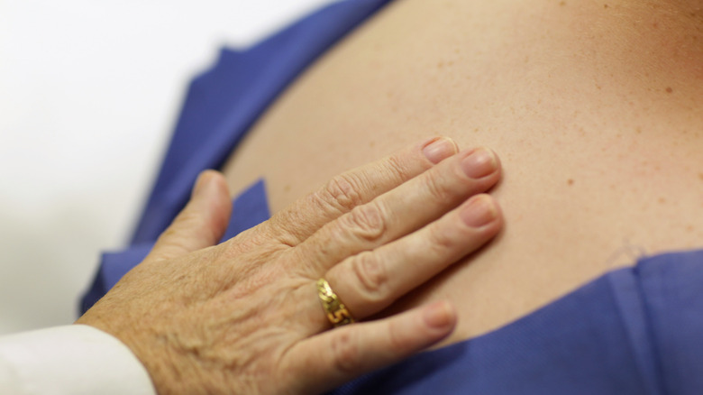 Doctor checks patient for sign of skin cancer