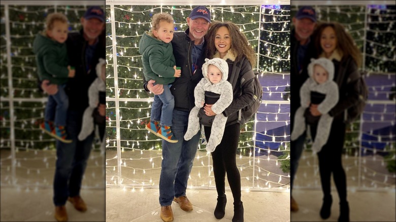 Ashley Darby and Michael Darby smiling with their two children