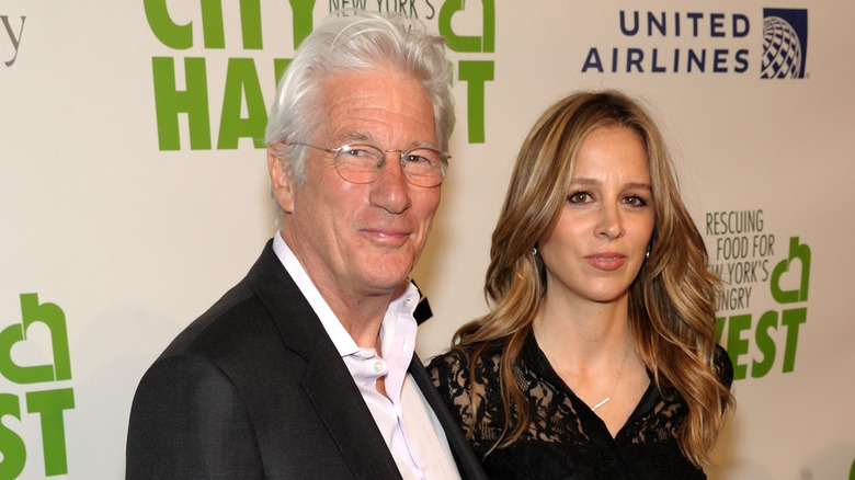 Richard Gere smiles next to his wife Alejandra Silva