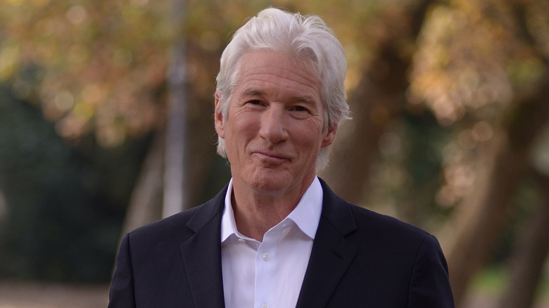 Richard Gere smiles in black suit