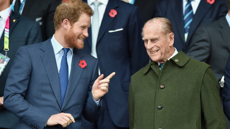 Prince Harry speaking with Prince Philip