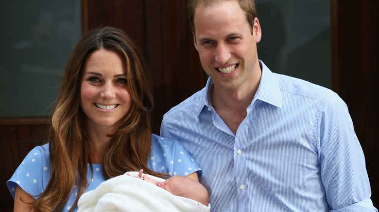 Prince William and Kate Middleton holding Prince George