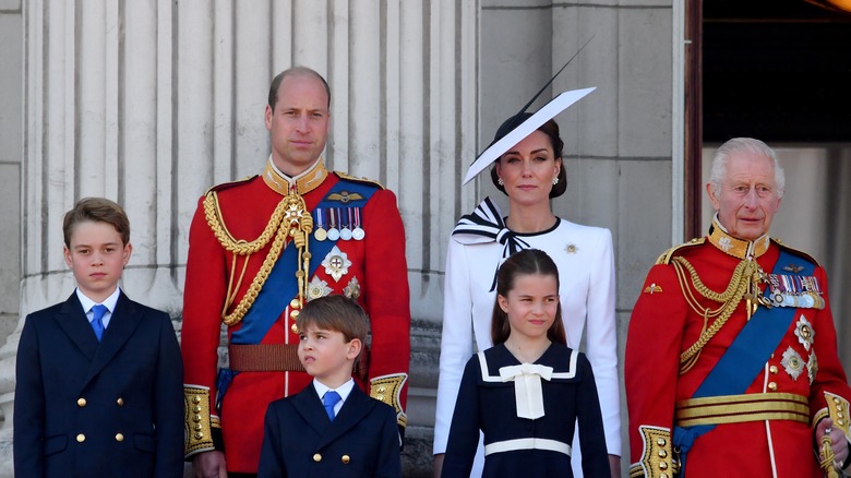 The royal family standing on balcony