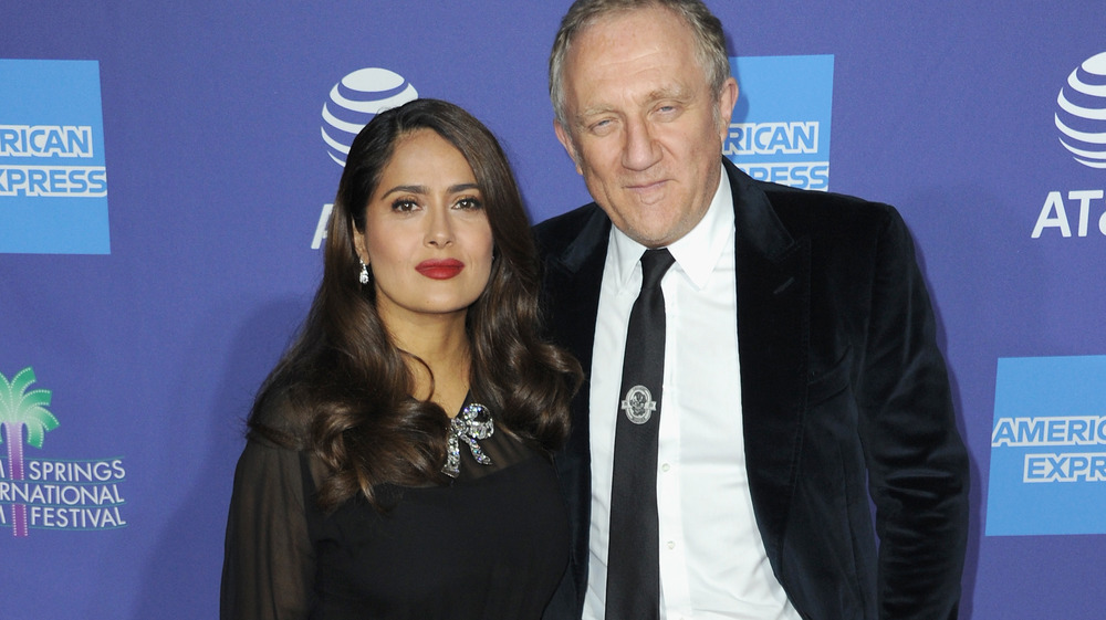 Salma Hayek with bold red lipstick and husband François-Henri Pinault