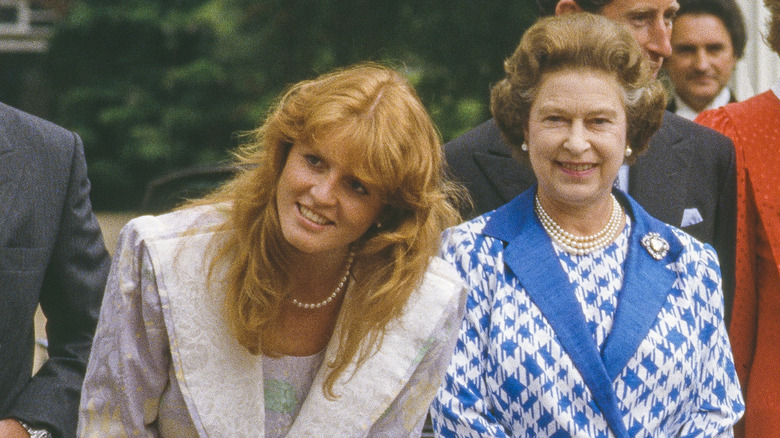 Fergie looking and smiling with Queen Elizabeth smiling beside her