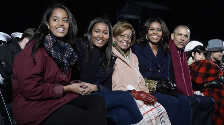 Malia and Sasha Obama sitting with their family