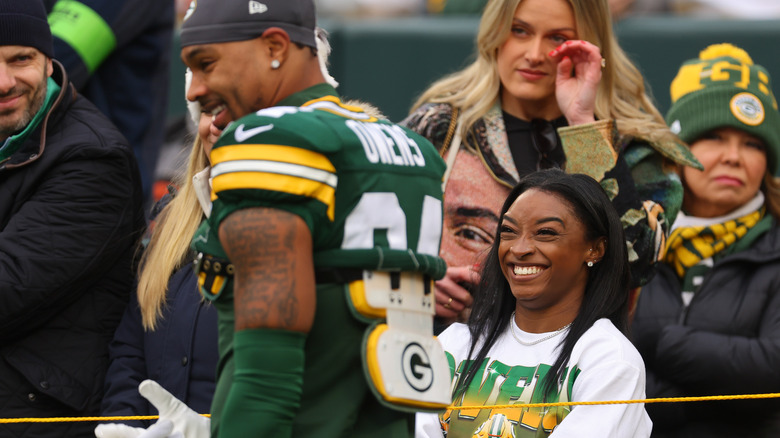 Simone Biles smiles at husband Jonathan Owens during a football game