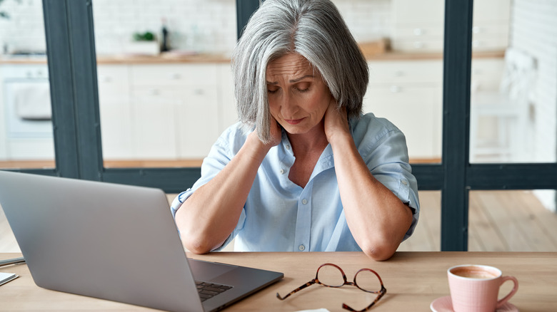 Woman rubbing her sore neck