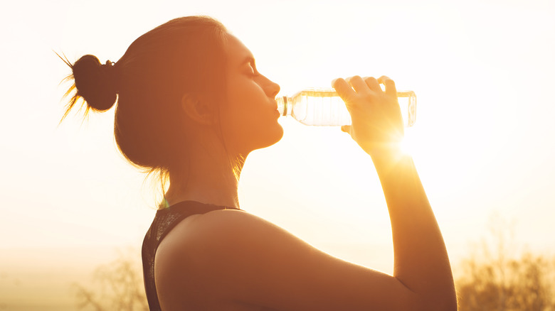 woman drinking water from bottle